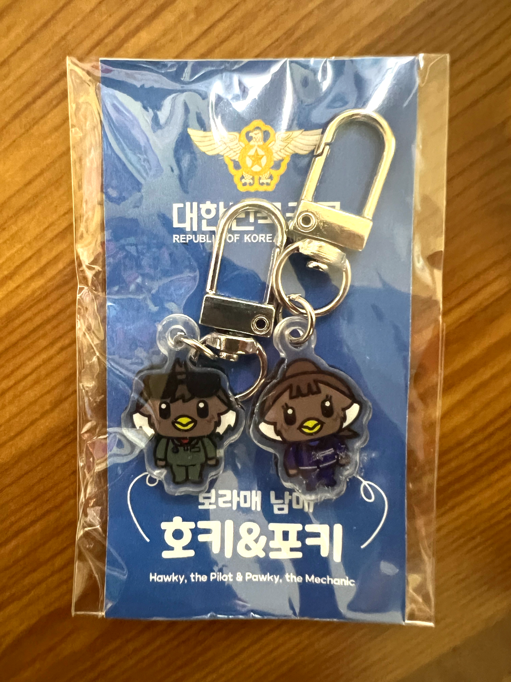 Hoki Poki acrylic keyrings in their packaging