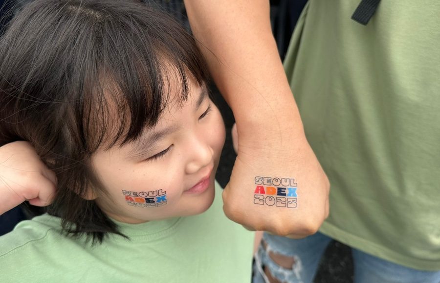 ADEX 2025 temporary tattoos on a visitor