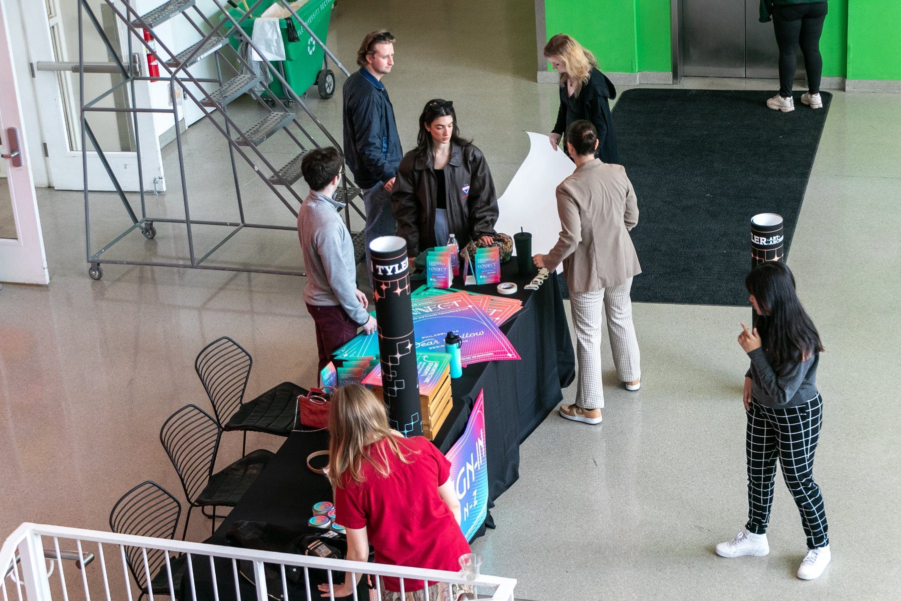Check-in table set up in the lobby with signage, coasters and name tags
