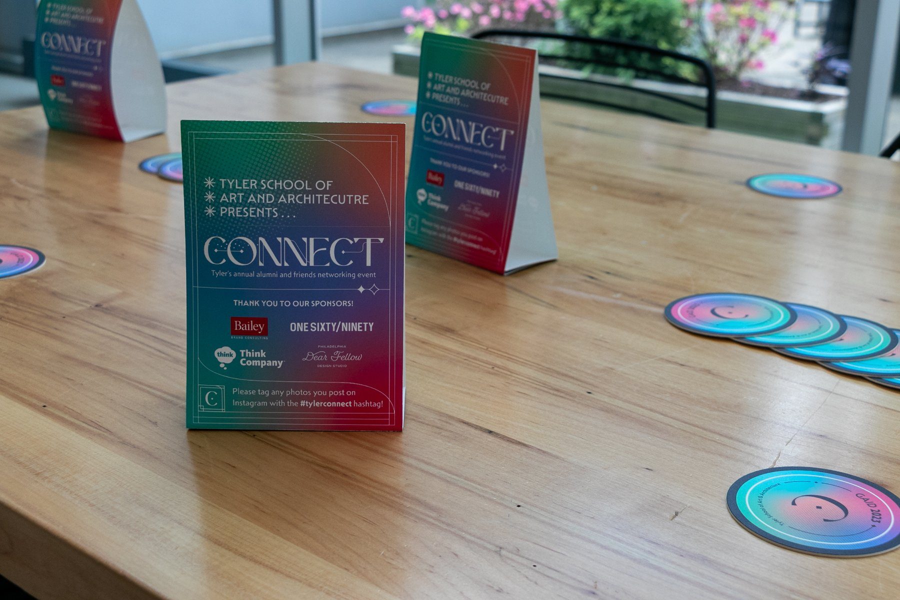 Table tents and coasters placed on courtyard tables before guests arrive